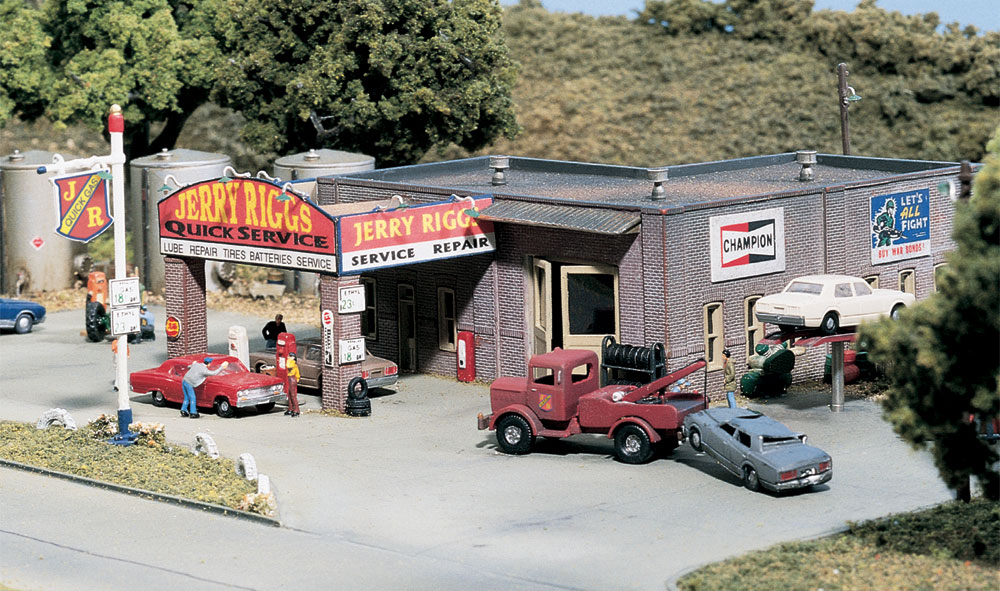 Jerry Riggs Quick Service - N Scale Kit - Full-service is alive and well on your layout! Vintage service station includes more than 130 details, including a tow truck, wrecked car, billboard, tire rack and tires, sign lights, gas station sign, fork lift, compressor, small kerosene tank, dry transfer decals and more! See photos for footprint