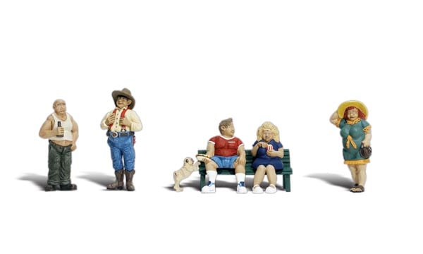 Full Figured Folks -  HO Scale - A man and a woman sit on a park bench, the woman holds her popcorn, while the man remains totally unaware of the pudgy pug dog trying to steal his hot dog