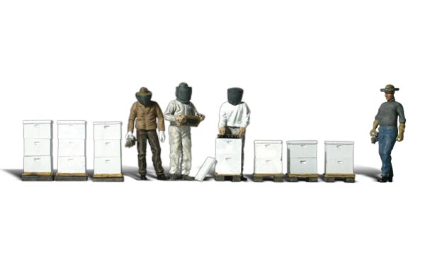 Beekeepers - N scale - An assortment of small and large hives, four beekeepers in full beekeeping gear and smokers to drive the bees from the hives while they harvest honey