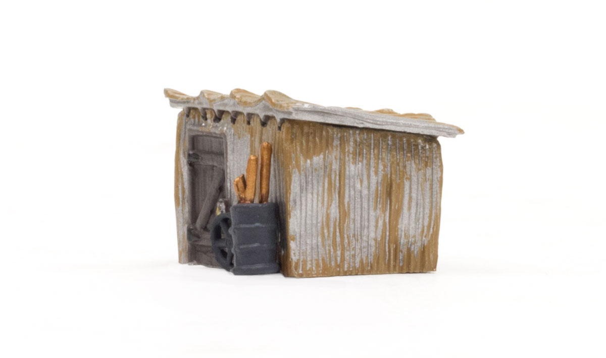 Tin Shack - N Scale - The Tin Shack's rusted metal walls and weather beaten door shows its true age after standing tall through rain, sun, and snow