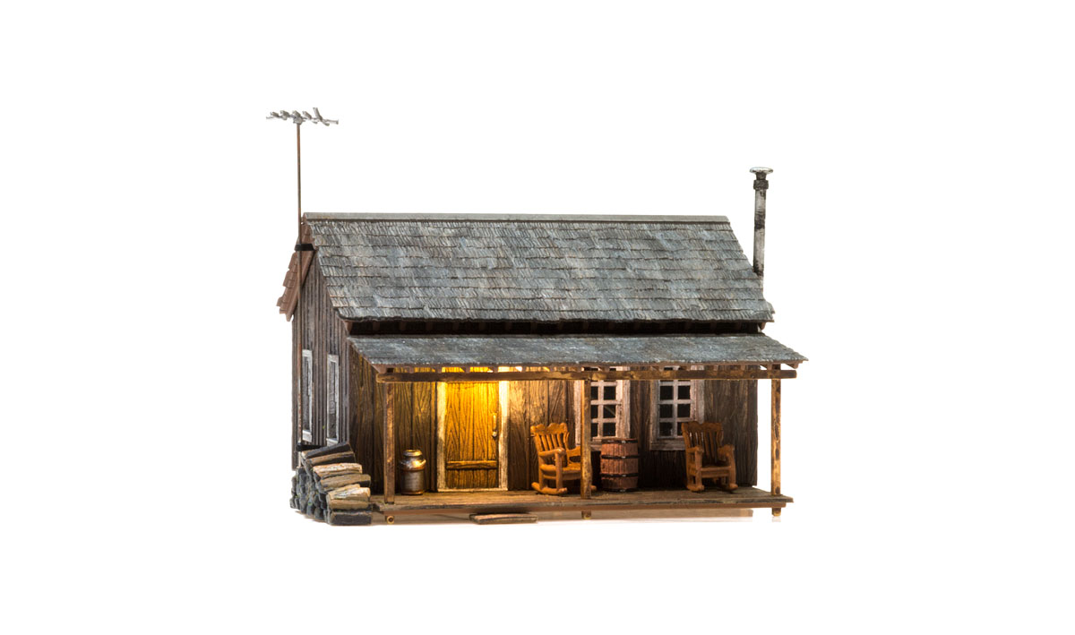 Rustic Cabin - N Scale - Whether you're looking for a getaway in the woods or a home with some country appeal, the Rustic Cabin is the perfect place to sit back and relax in a rocking chair