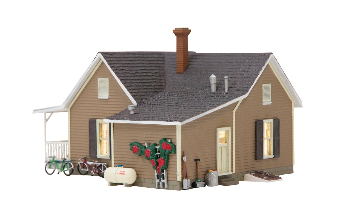 Granny's House - HO Scale - Granny's House is a quaint little home with a rose arbor and Granny's living room rug airing out on the porch