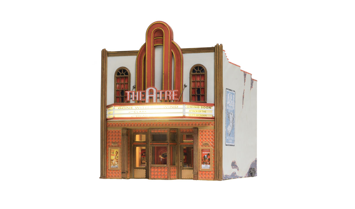 Theatre - HO Scale - The Theatre offers classic vintage architecture, an expertly weathered stucco-over-brick exterior, tall arched windows, gilded kick plates on front doors, a decorative tile facade and carved wood trim