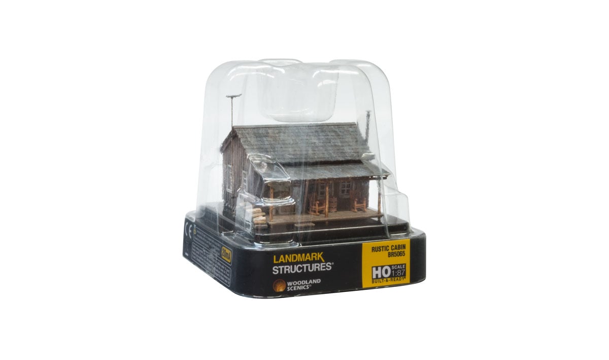 Rustic Cabin - HO Scale - Whether you're looking for a getaway in the woods or a home with some country appeal, the Rustic Cabin is the perfect place to sit back and relax in a rocking chair