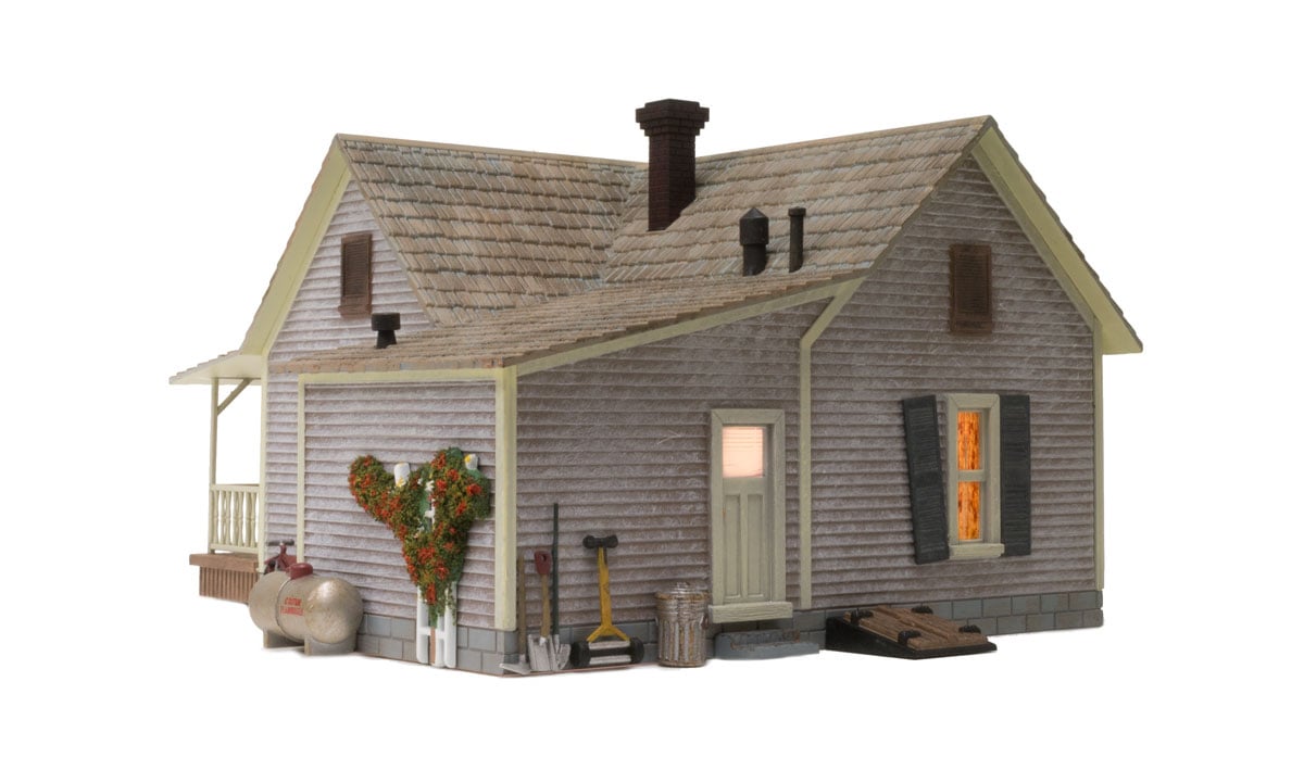Old Homestead - O Scale - The Old Homestead is a bit rough around the edges and the perfect representation of an old rural bungalow, beautifully weathered and loaded with detail including old Bowser asleep on the front porch