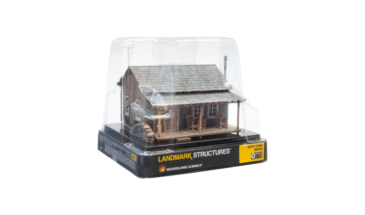 Rustic Cabin - O Scale - Whether you're looking for a getaway in the woods or a home with some country appeal, the Rustic Cabin is the perfect place to sit back and relax in a rocking chair