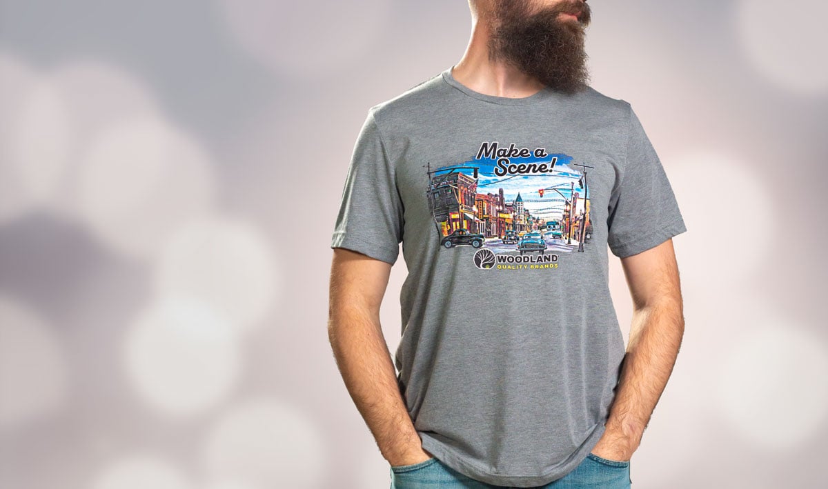 Make a Scene™ T-Shirts  -  Make a Scene&trade; with this artistic Woodland Quality Brands T-shirt! This colorful T-shirt features a detailed miniature scene showcasing new and classic Woodland Scenics® products